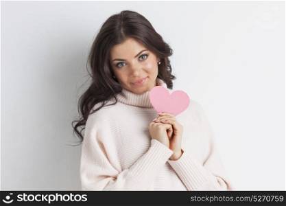 Smiling woman with paper heart. Happy young smiling woman with pink paper heart
