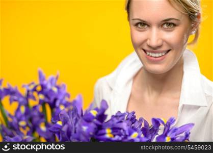 Smiling woman with spring blue flowers iris