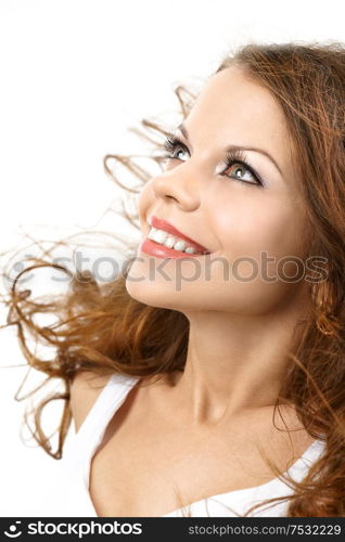 Smiling woman with the flying curly hair, isolated
