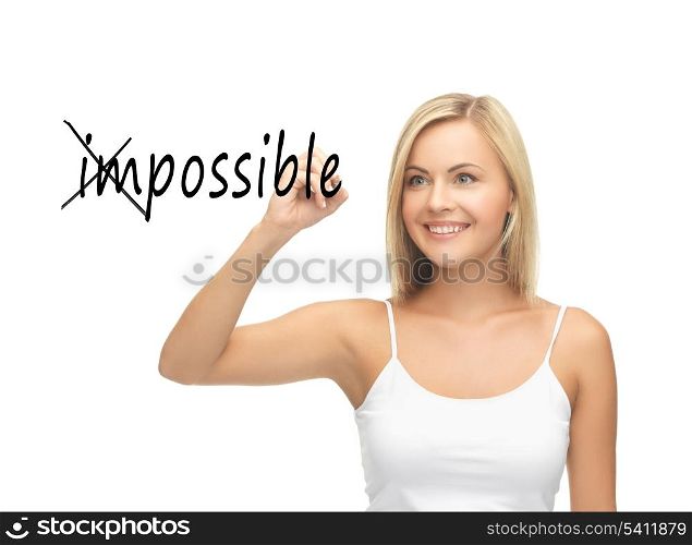 smiling woman writing the word (im)possible in the air