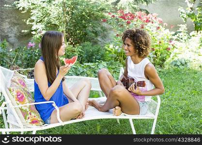 Smiling women relaxing in backyard
