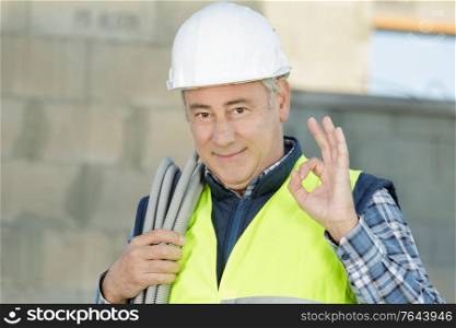 smiling worker gesturing ok sign