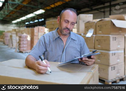 smiling worker standing with arms crossed