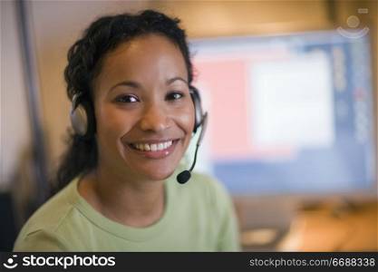 Smiling young African American woman with headset and microphone