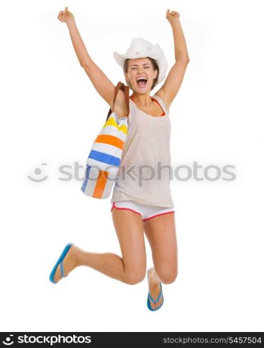 Smiling young beach woman in hat jumping