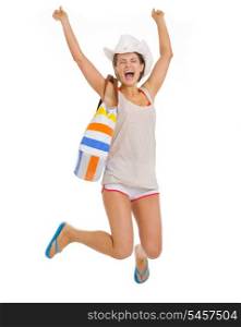 Smiling young beach woman in hat jumping