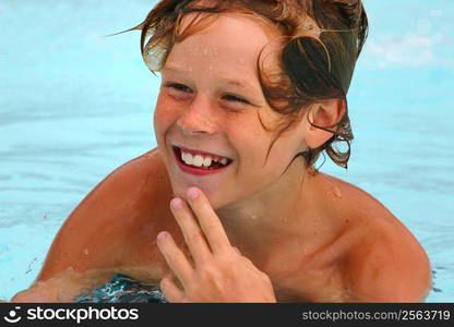 Smiling young boy in a swimming pool