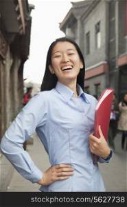 Smiling young business woman in houhai, Beijing, China