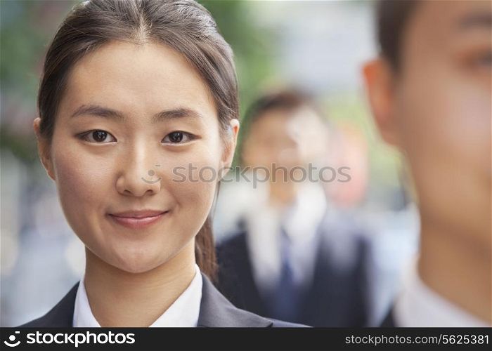Smiling Young Businesswoman Looking at Camera