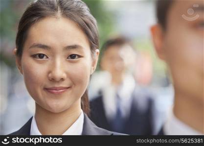 Smiling Young Businesswoman Looking at Camera