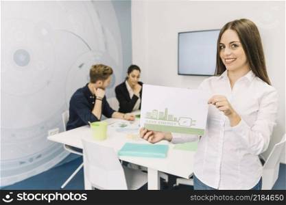 smiling young businesswoman showing energy saving concept office
