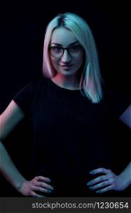 smiling young Caucasian beautiful blonde woman with glasses . close-up portrait in neon light