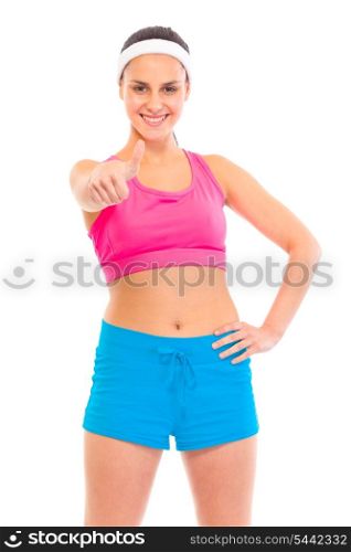 Smiling young confident girl in sportswear showing thumbs up gesture isolated on white&#xA;