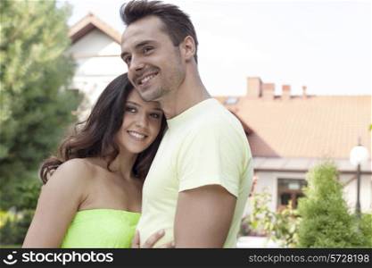 Smiling young couple embracing outdoors