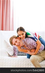 Smiling young couple having fun time at home&#xA;