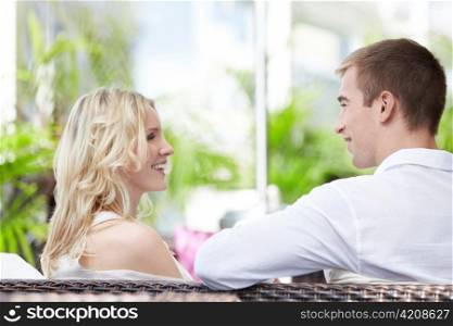Smiling young couple in a cafe