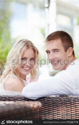 Smiling young couple in restaurant