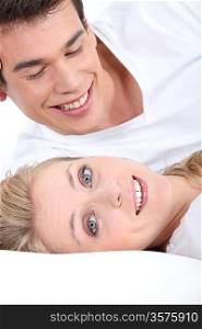 Smiling young couple lying down