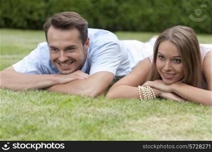 Smiling young couple lying on grass