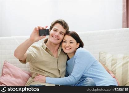 Smiling young couple making self photo