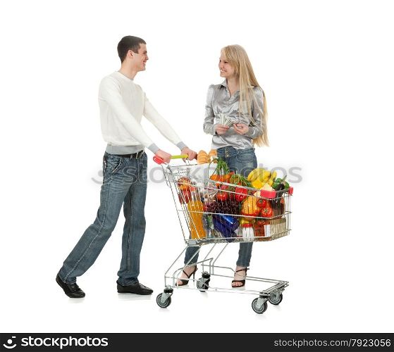 Smiling Young Couple Standing Together with Shopping Cart full of Food and Drink
