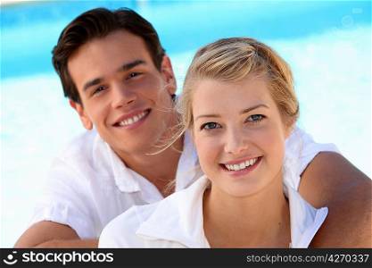 Smiling young couple with a blue sky background