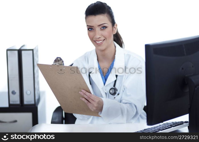 Smiling young doctor with clipboard in hand looking at the camera over white background