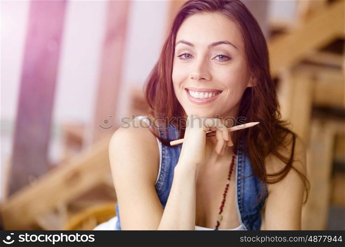 Smiling young female designer. Smiling young designer standing in creative office