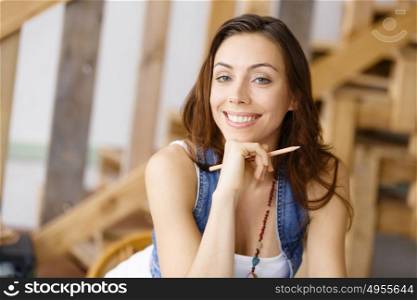 Smiling young female designer. Smiling young designer standing in creative office