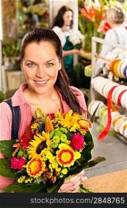 Smiling young florist woman colorful bouquet shop flowers selling