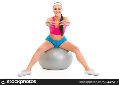 Smiling young girl doing exercises on fitness ball isolated on white&#xA;