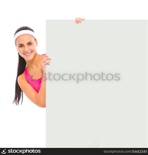 Smiling young girl looking out from blank billboard isolated on white&#xA;