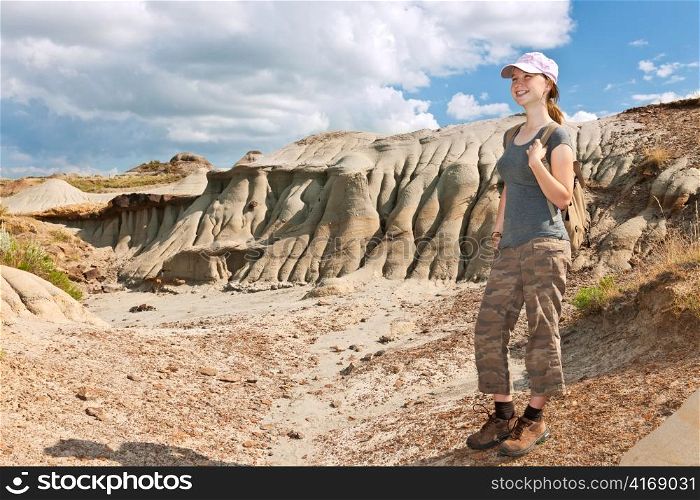 Smiling young girl standing at the Badlands in Dinosaur provincial park, Alberta, Canada