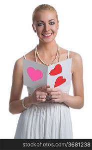 smiling young girl with blonde hait and white dress takes in the hands valentine postcard