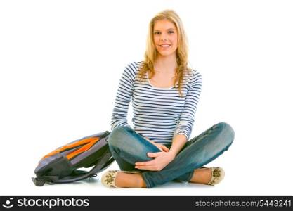 Smiling young girl with schoolbag sitting on floor isolated on white &#xA;