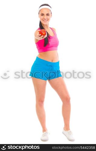 Smiling young healthy girl in sportswear giving red apple isolated on white&#xA;