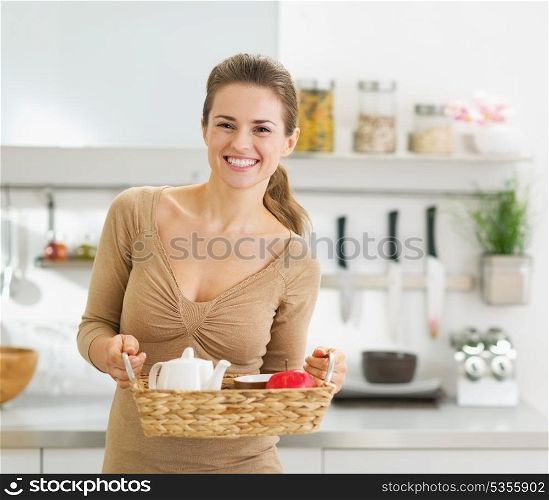 Smiling young housewife with breakfast tray