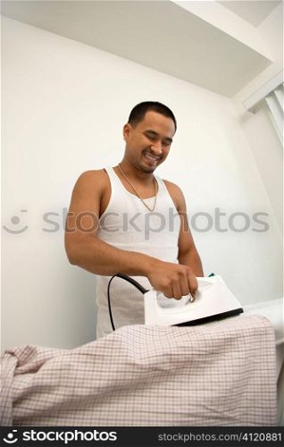 Smiling Young Man Ironing