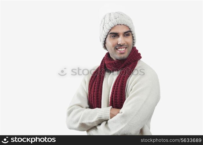 Smiling young man looking away over white background