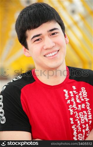 smiling young man on footbridge