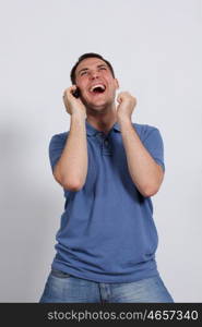 Smiling young man on his mobile phone against a white background