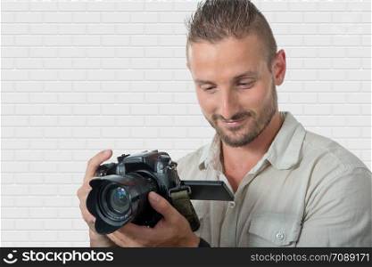 smiling young man photographer with dslr camera