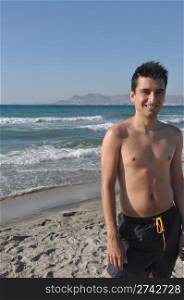 smiling young man relaxing at Kos beach in Greece (blue sky)