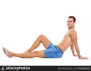 Smiling young man sitting and tanning
