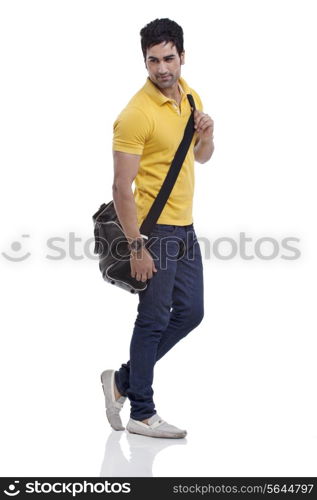 Smiling young man with duffel bag over white background