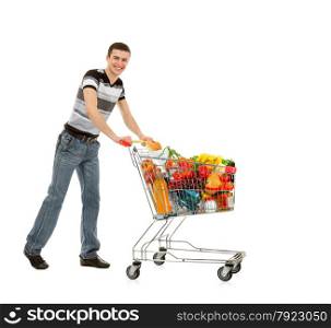 Smiling Young Man with Shopping Cart full of Food and Drink on the White Background