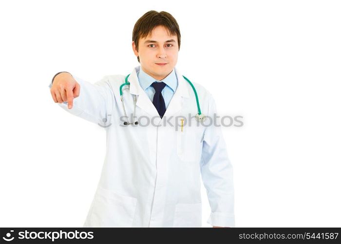 Smiling young medical doctor pointing finger down isolated on white&#xA;
