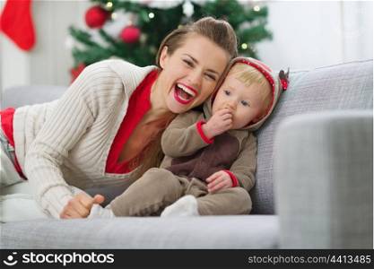 Smiling young mother and baby having fun time on Christmas