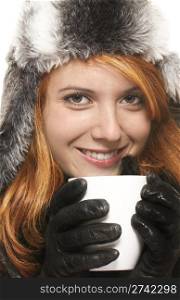 smiling young redhead woman in winter dress holding coffee cup . smiling young redhead woman in winter dress holding coffee cup on white background