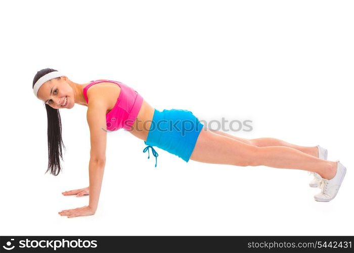Smiling young sportsgirl doing push-up isolated on white&#xA;
